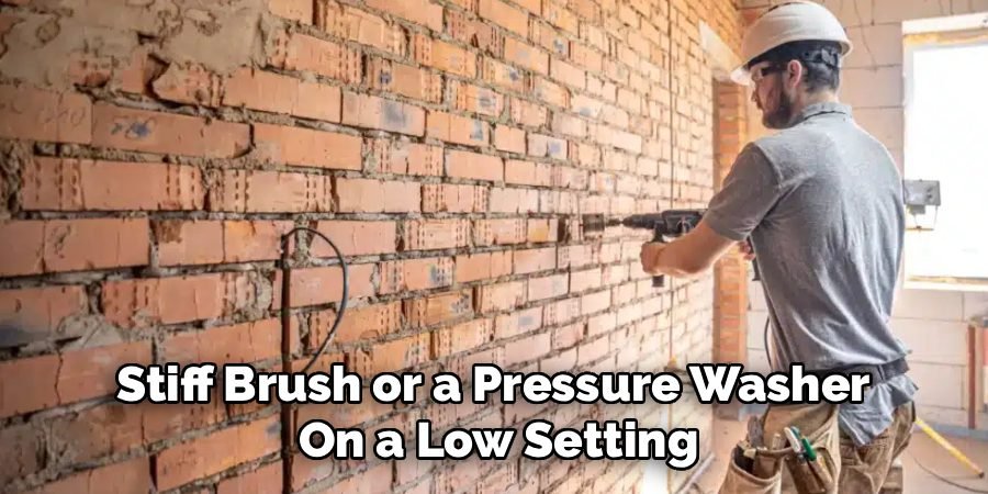 Stiff Brush or a Pressure Washer 
On a Low Setting