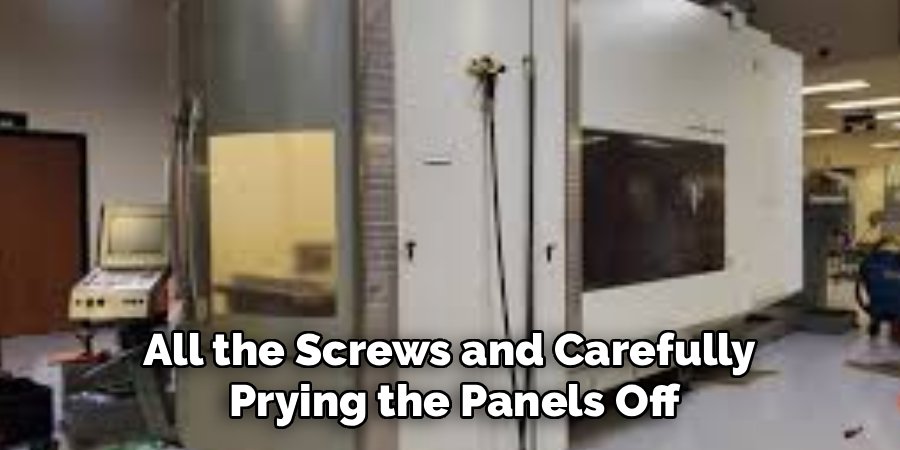 All the Screws and Carefully 
Prying the Panels Off